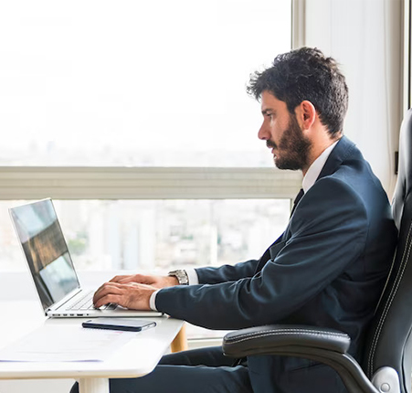 young-businessman-working-laptop-workplace_23-2147857309